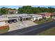 Well-maintained exterior featuring a carport, landscaped garden, and an American flag at 4039 La Pasida Ln, New Port Richey, FL 34655