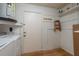 A utilitarian utility room with washer, dryer, water heater, and shelving for storage at 4039 La Pasida Ln, New Port Richey, FL 34655