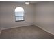 Bedroom featuring neutral carpet, light walls, and a window at 405 Lemonwood Dr, Englewood, FL 34223
