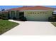 Charming single-story home with a red tile roof and well-maintained landscaping at 405 Lemonwood Dr, Englewood, FL 34223