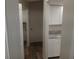 Hallway featuring white cabinets with granite countertops and nearby closet at 405 Lemonwood Dr, Englewood, FL 34223