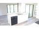 Kitchen island with undermount sink, granite countertop, stainless faucet and black dishwasher at 405 Lemonwood Dr, Englewood, FL 34223