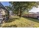 An expansive backyard with a wood fence and mature trees providing plenty of shade at 447 Bridle Path Way, Tarpon Springs, FL 34688