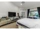 This bright bedroom has a large window, mirrored dressers, and stylish light fixture at 447 Bridle Path Way, Tarpon Springs, FL 34688