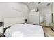 A spacious main bedroom with vaulted ceilings, stylish decor, and a view to the ensuite bathroom at 447 Bridle Path Way, Tarpon Springs, FL 34688
