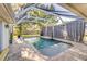 Serene pool area with screened enclosure, mature landscaping, and privacy at 447 Bridle Path Way, Tarpon Springs, FL 34688