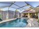 Relaxing pool area with covered screen, ample space for seating, and privacy at 447 Bridle Path Way, Tarpon Springs, FL 34688
