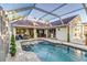 Beautiful screened-in pool area with brick pavers and plenty of space for entertaining at 447 Bridle Path Way, Tarpon Springs, FL 34688
