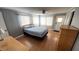 Inviting bedroom with natural light, ceiling fan, and laminate wood flooring at 4851 W Gandy Blvd # B7L23, Tampa, FL 33611