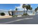 Exterior shot featuring an attached carport, mature landscaping, and neat exterior at 4851 W Gandy Blvd # B7L23, Tampa, FL 33611