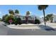 Charming single-story home featuring a red front door, well-maintained landscaping, and a bright, inviting facade at 4851 W Gandy Blvd # B7L23, Tampa, FL 33611