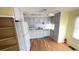 Well-lit kitchen featuring white cabinets, laminate flooring, and ample storage space at 4851 W Gandy Blvd # B7L23, Tampa, FL 33611