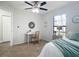 Well-lit bedroom with large window, ceiling fan, neutral walls and carpeted floors at 5580 S Salford Blvd, North Port, FL 34287