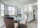 Sunlit dining area featuring a glass-top table, wicker chairs and adjacent to the kitchen at 5580 S Salford Blvd, North Port, FL 34287