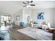 Open-concept living room and dining area with wood floors, vaulted ceilings, and abundant natural light at 5580 S Salford Blvd, North Port, FL 34287