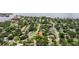 Aerial view of a house situated in a neighborhood near the water, surrounded by mature trees and green spaces at 5800 3Rd S St, St Petersburg, FL 33705