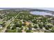 A panoramic aerial view of a home in a leafy suburb near a lake and with a city skyline in the distance at 5800 3Rd S St, St Petersburg, FL 33705