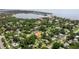 Aerial view of a charming home nestled in a lush, green neighborhood with a view of a lake in the distance at 5800 3Rd S St, St Petersburg, FL 33705