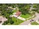 Aerial view of a quaint home with a long driveway, mature trees, and lush green landscaping, set in a quiet neighborhood at 5800 3Rd S St, St Petersburg, FL 33705