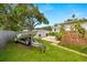 Green backyard featuring a boat and trailer with a storage shed next to the back of the house at 5800 3Rd S St, St Petersburg, FL 33705