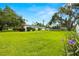 Expansive backyard with mature trees, a lush lawn, and potential for outdoor activities at 5800 3Rd S St, St Petersburg, FL 33705