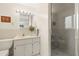 Well-lit bathroom features a marble vanity, toilet, and enclosed shower with glass doors at 5800 3Rd S St, St Petersburg, FL 33705
