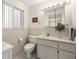 Clean bathroom featuring vanity with marble countertop, decorative mirror and soft lighting at 5800 3Rd S St, St Petersburg, FL 33705