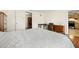 Spacious bedroom with wood floors leads to kitchen, showcases a dresser and work desk at 5800 3Rd S St, St Petersburg, FL 33705