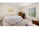 Bedroom with soft gray carpeting, dresser, and window with natural light at 5800 3Rd S St, St Petersburg, FL 33705