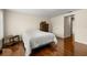Bedroom featuring wood floors, closet, a dresser, and bedside table at 5800 3Rd S St, St Petersburg, FL 33705
