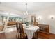 Chandelier-lit dining room showcasing hardwood floors and a formal dining table at 5800 3Rd S St, St Petersburg, FL 33705