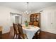 Formal dining area featuring hardwood floors, a hutch, and bright, open access at 5800 3Rd S St, St Petersburg, FL 33705