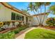 Charming home with vibrant flower beds, a walkway leading to the front door, and mature palm trees at 5800 3Rd S St, St Petersburg, FL 33705