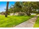 Charming home with a lush front yard, mature tree, and well-maintained lawn at 5800 3Rd S St, St Petersburg, FL 33705