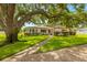 Charming single-story home with a lush front yard, mature tree, and sidewalk appeal at 5800 3Rd S St, St Petersburg, FL 33705