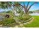 Well-kept garden with pathways, flower beds, and a mature tree, ideal for gardening enthusiasts at 5800 3Rd S St, St Petersburg, FL 33705