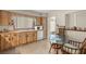 Cozy eat-in kitchen features wood cabinets, neutral tile floor, and a sunny window at 5800 3Rd S St, St Petersburg, FL 33705