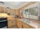 Bright kitchen featuring wood cabinets, tile backsplash, double bowl sink and window view at 5800 3Rd S St, St Petersburg, FL 33705