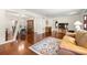 Open-concept living room with hardwood floors flowing into the dining area, creating a seamless living space at 5800 3Rd S St, St Petersburg, FL 33705