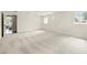 Bright, spacious living room features plush gray carpeting and ample natural light at 5800 3Rd S St, St Petersburg, FL 33705