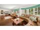 Spacious living room with hardwood floors, large windows, and comfortable seating, perfect for relaxation at 5800 3Rd S St, St Petersburg, FL 33705