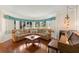 Inviting living room with hardwood floors, a comfortable sectional sofa, and natural light from the bay window at 5800 3Rd S St, St Petersburg, FL 33705