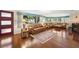 Bright living room featuring hardwood floors, a stylish rug, and a cozy seating arrangement at 5800 3Rd S St, St Petersburg, FL 33705