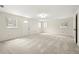 Spacious living space featuring carpet floors, multiple windows and a bright interior at 5800 3Rd S St, St Petersburg, FL 33705