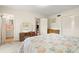 Bright main bedroom featuring neutral walls, carpet, and furnishings plus an ensuite bathroom at 5800 3Rd S St, St Petersburg, FL 33705