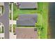 Aerial view of a home with a lush green lawn, a serene pond and manicured landscaping at 6097 Golden Nettle Dr, Apollo Beach, FL 33572