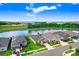 Pond view homes featuring manicured lawns and pristine landscaping in a vibrant community at 6097 Golden Nettle Dr, Apollo Beach, FL 33572