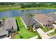 Community aerial showcasing pond view homes, green lawns and sidewalks in a desirable neighborhood at 6097 Golden Nettle Dr, Apollo Beach, FL 33572