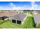 Aerial shot of the house showing a screened lanai and well maintained backyard in a peaceful neighborhood at 6097 Golden Nettle Dr, Apollo Beach, FL 33572