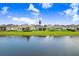 Rear view of a lovely home featuring a screened lanai and serene pond views from the backyard at 6097 Golden Nettle Dr, Apollo Beach, FL 33572